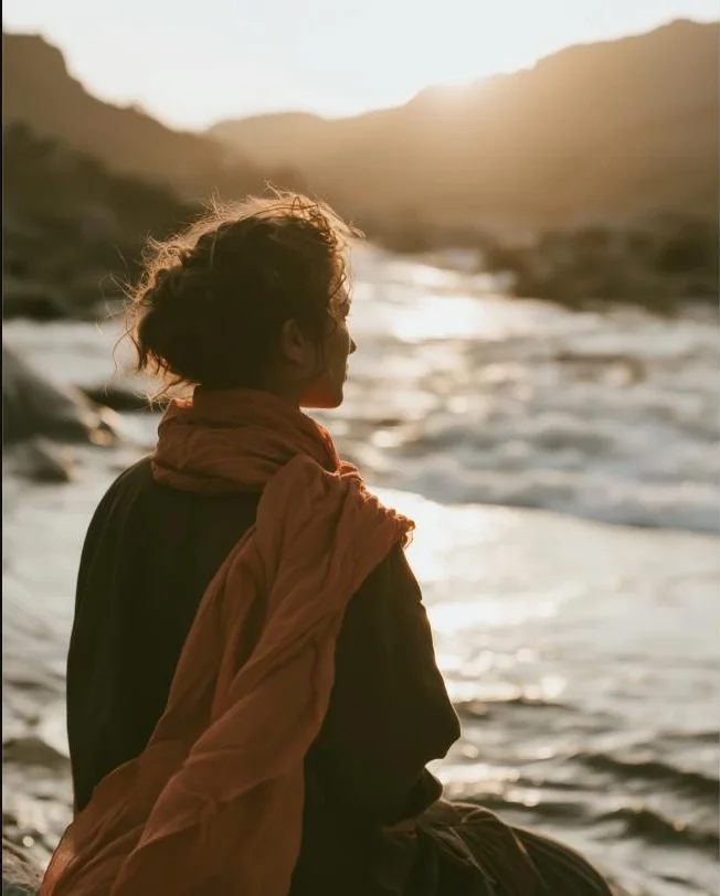 figure by the river at golden hour